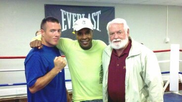 BJ Barrett with his father and Sugar Ray Leonard in a boxing gym