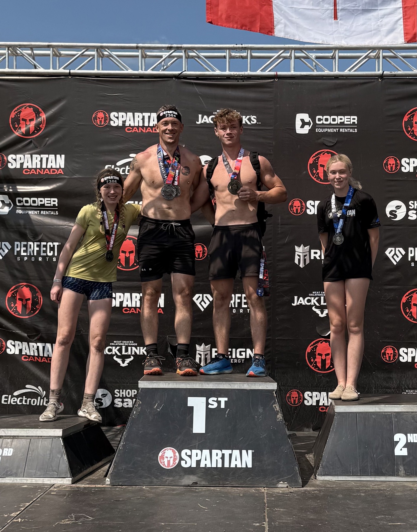 Luke Anderson with his son and twin daughters after completing a Spartan Canada race together